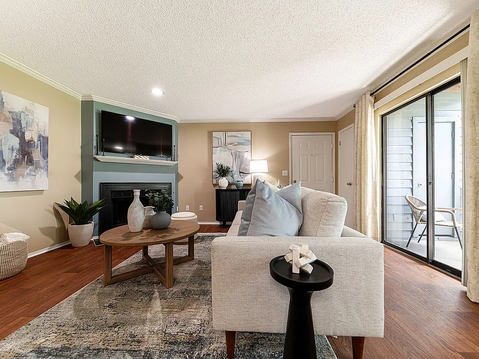 Spacious living room with hardwood-style flooring & fireplace
