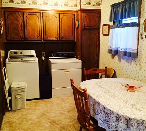 Laundry area with an extra wall of cabinets. Door to the garage is to the left.