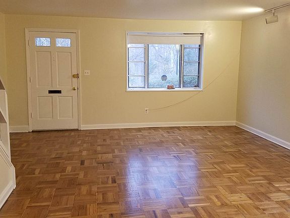 LIVING ROOM DINING ROOM END UNIT TOWNHOUSE LOOKS AOVER A FOREST.