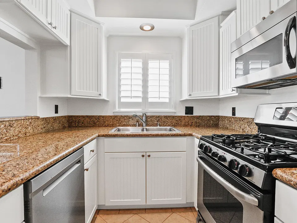 Kitchen with custom cabinetry, pull-out shelving, built-in spice rack and lazy susan
