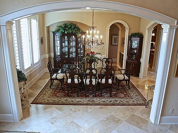 Beautiful formal dining room is on the left when you enter the home, enough room to seat ten. In the