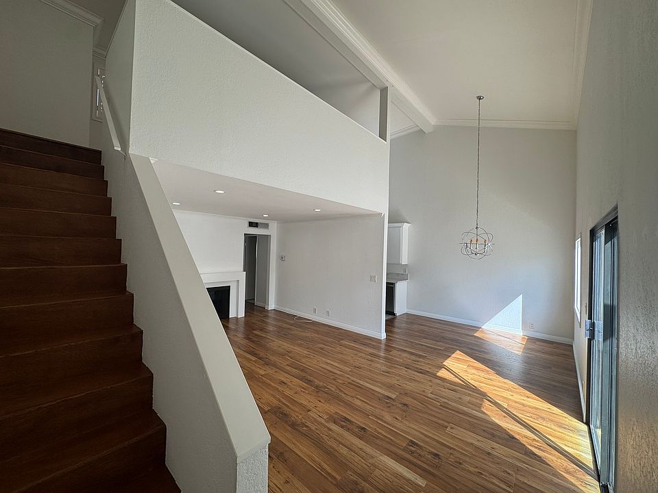 View of the living room, dining room, and stairs going to the loft.