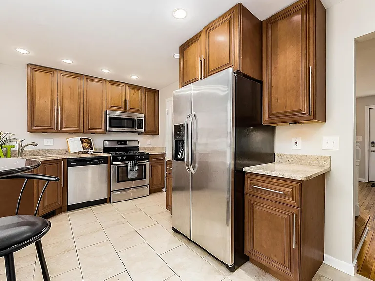 Kitchen with new stainless steel fridge