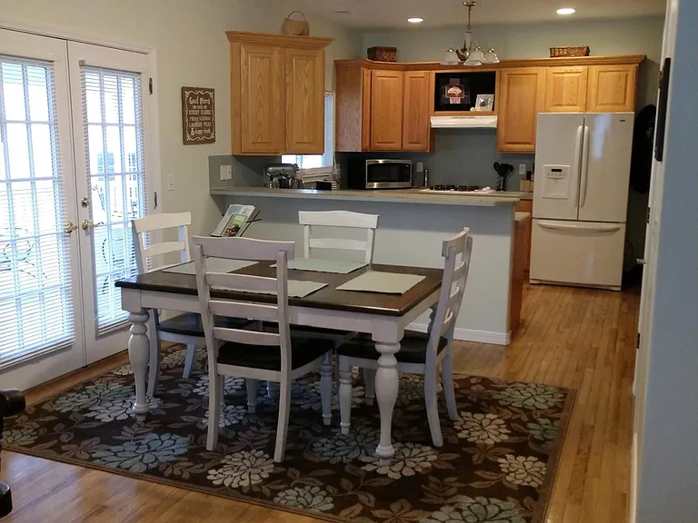 Dining and kitchen area with French doors to back covered deck