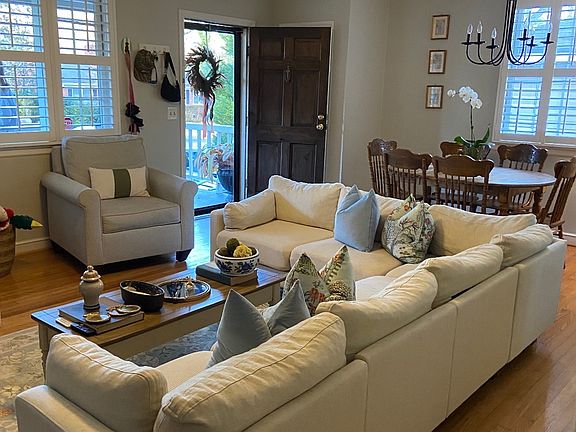Spacious living room with coat closet and dining area