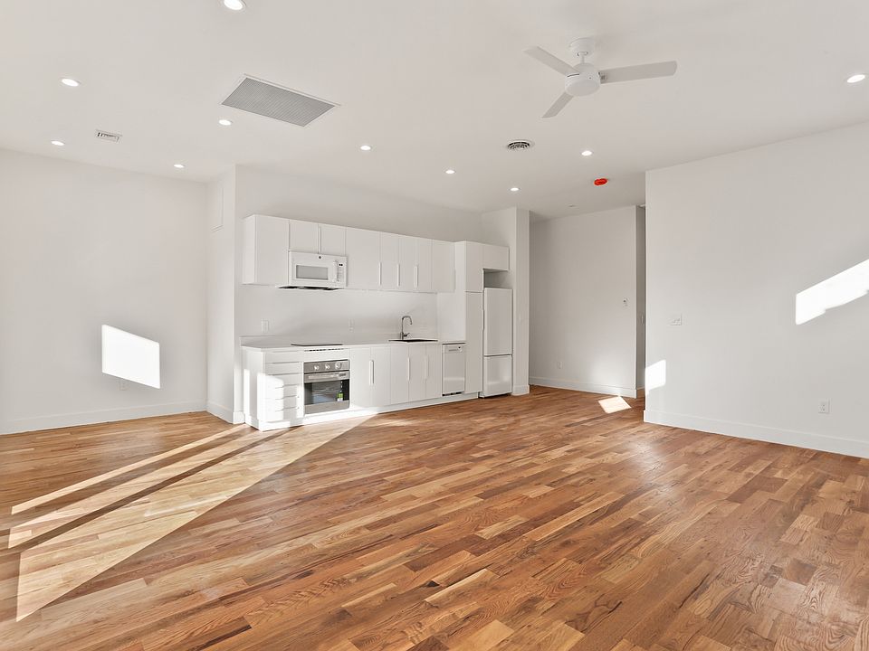 Full kitchen with stainless steel oven and induction cooktop.