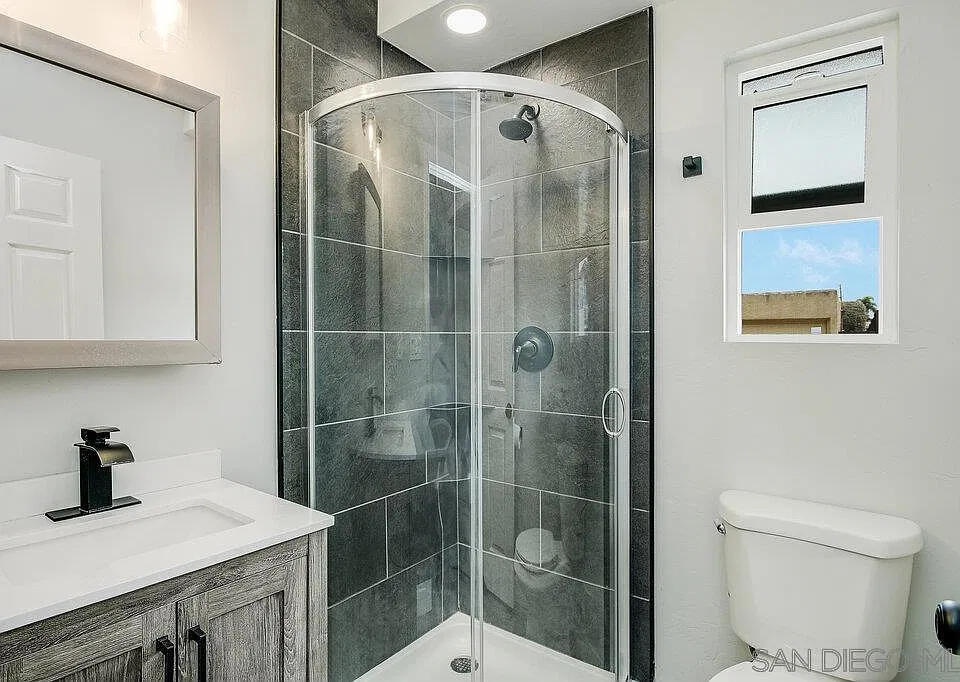 Modern bathroom with tiled shower and updated vanity