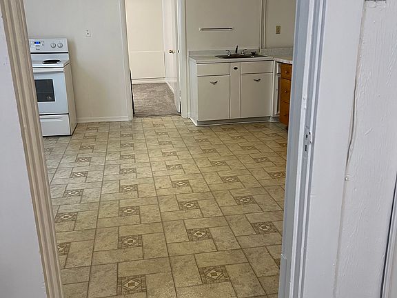 large kitchen with range and refrigerator