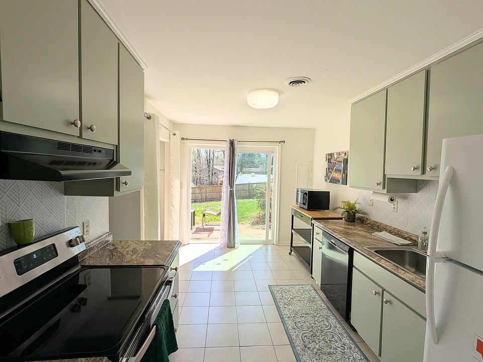 Big Kitchen opens to sunny patio. Sage green kitchen cabinets, updated appliances, dish washer, tile floors