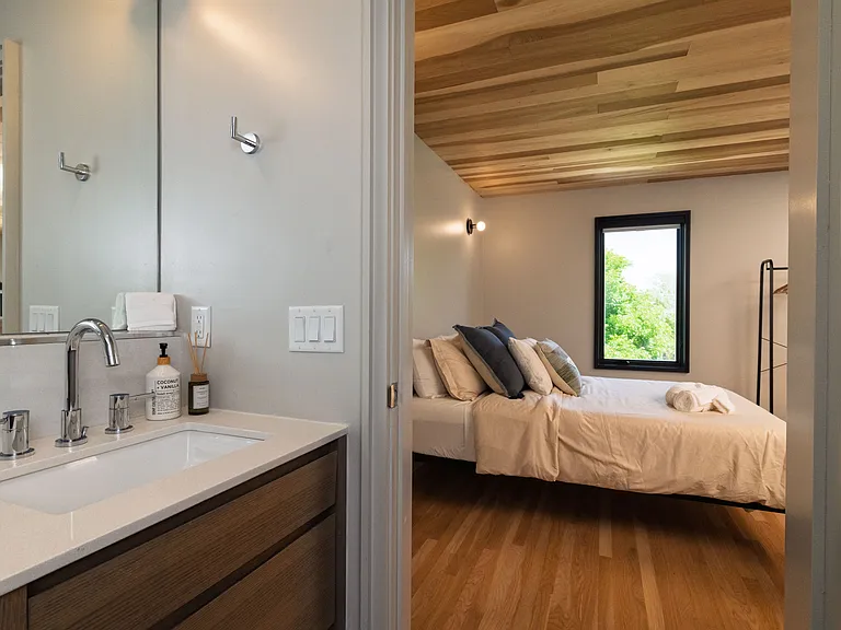 Bathroom 2 has a walk in shower and a cabinet sink with mirror.