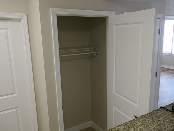 Coat closet upon entry. Door pictured to the left is entrance to bathroom (there is also an entrance from the bedroom)