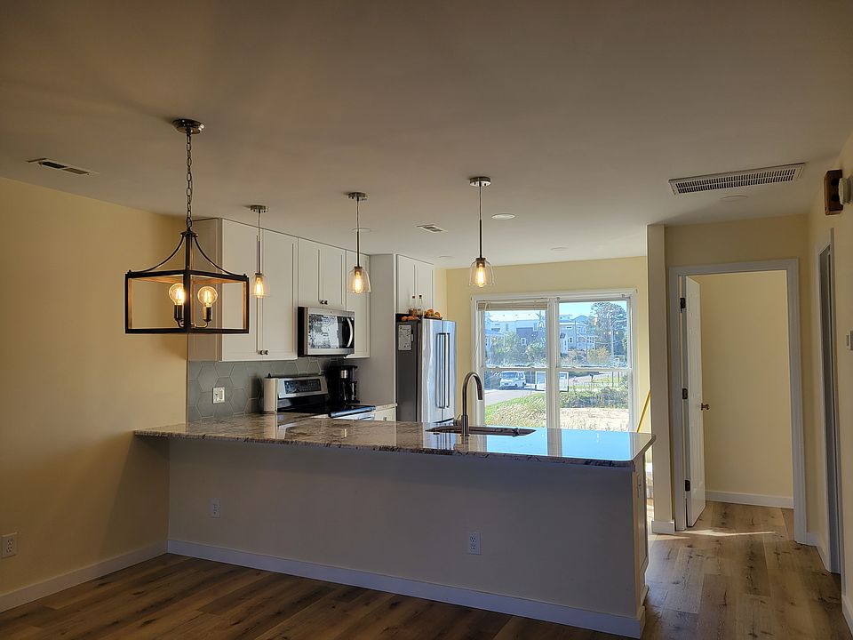 Newly remodeled kitchen boasts granite counter tops and stainless steel appliances as well as southern exposure for beautiful natural light.