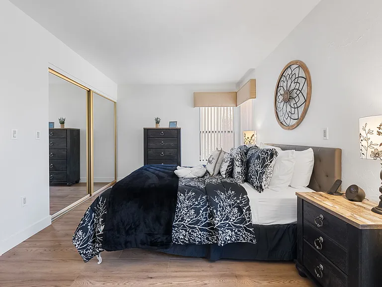 A spacious and inviting downstairs bedroom with creek views .