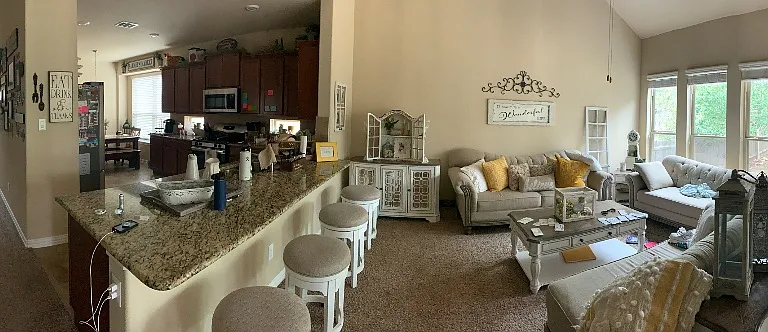 Panorama of the Living Room w/back door entrance, kitchen, hall (leading to the front door/room) and stairway