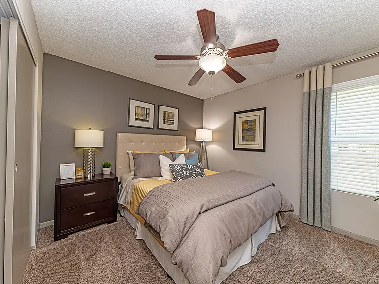 Cozy bedroom with carpet and overhead lighting