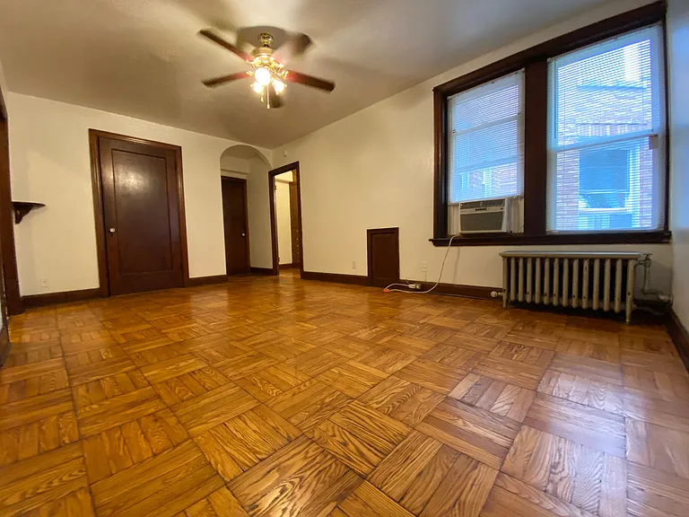 Ceiling fan and parquet wood flooring.