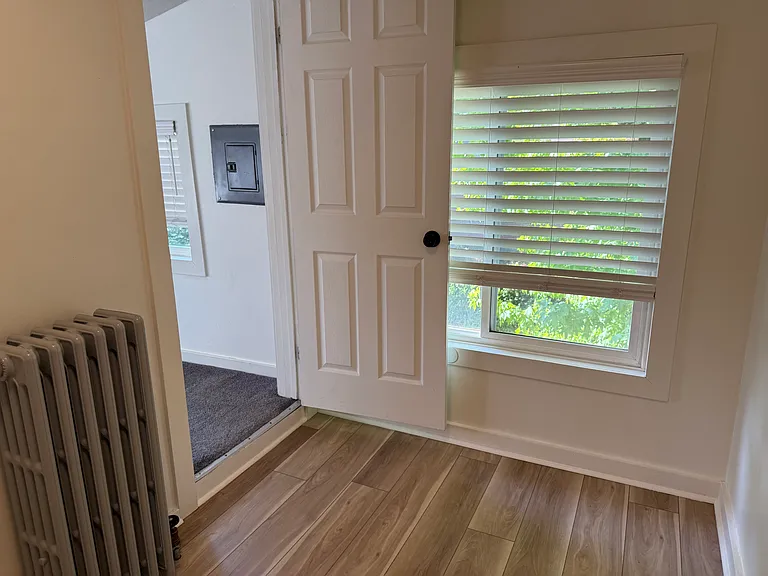 standing near fridge looking toward south window in kitchen, BR2 door on left