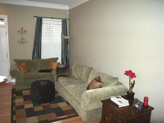 Greatroom, as the rest of the rooms on the main level, has plantation shutters