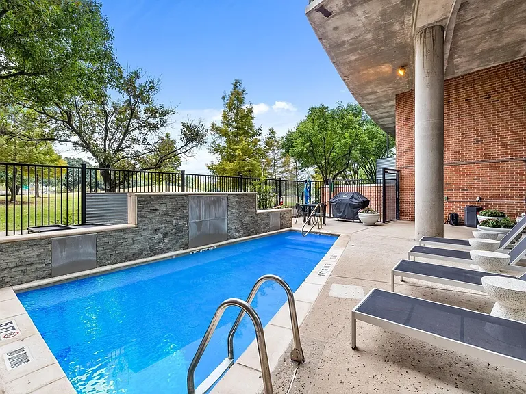 Outdoor swimming pool with waterfall features