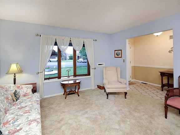 Entry into living room with bay window.