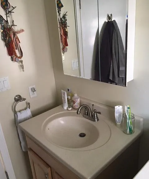Trifold vanity mirror and solid surface sink