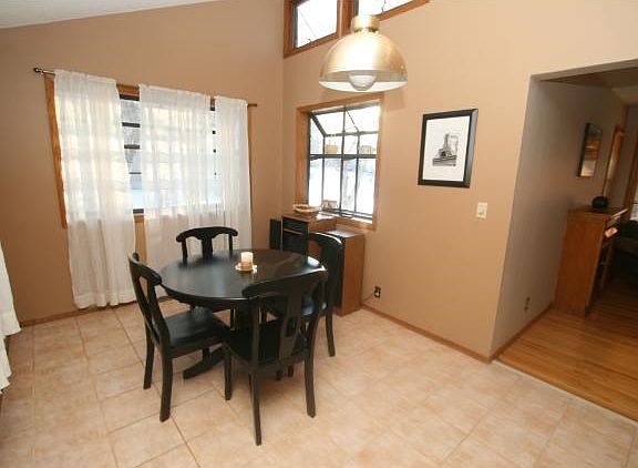 Bright dining area featuring high ceilings and skylights.