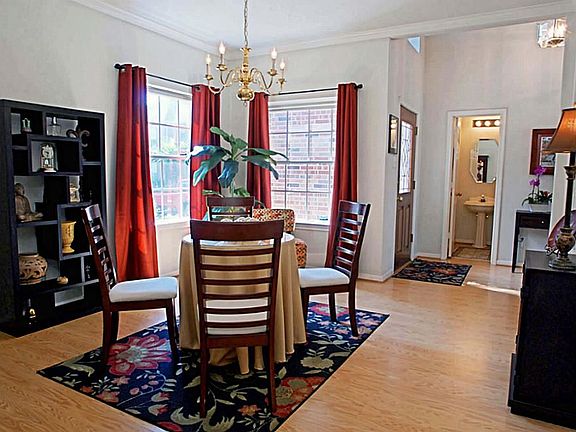 View of light and bright dining room looking from the kitchen toward the entry.