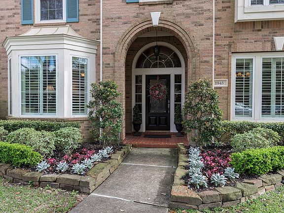 The front elevation features beautiful landscaping, lovely entry and recent Low E double paned windows.