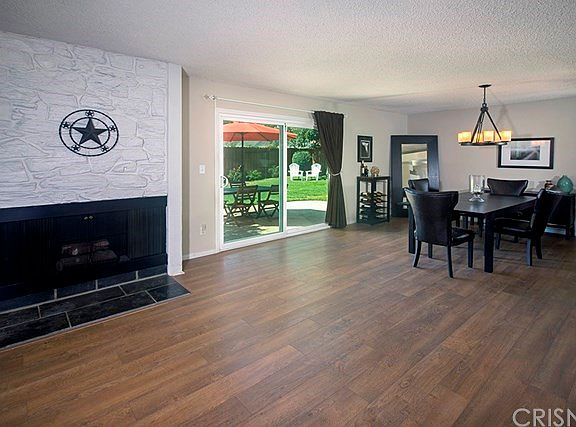 Newer flooring in this beautiful living room, A fireplace for those cozy nights and light filled roo