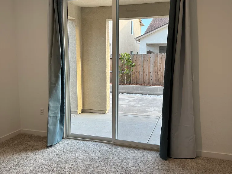 Bedroom sliding glass door to backyard.