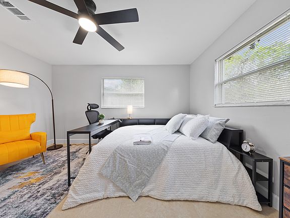 Natural light, ceiling fan, area rug a real bedroom, not just a place to sleep.