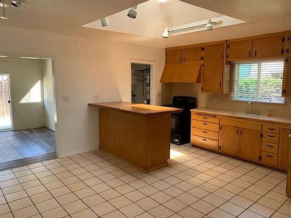 Kitchen with prep or eating counter, gas cooking.