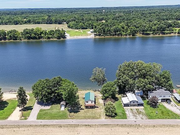 LIFE ON THE RIVER! This gem is nestled along the picturesque banks of ...