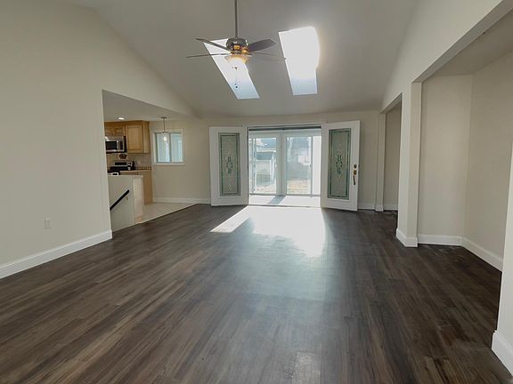 Bright and airy - the Great Room leads to the kitchen, steps to the lower level, and the South-facing Sun Room.