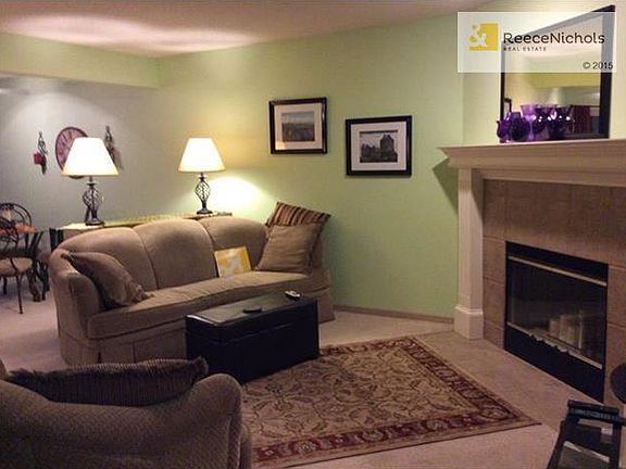 Living room is comfy and freshly painted.