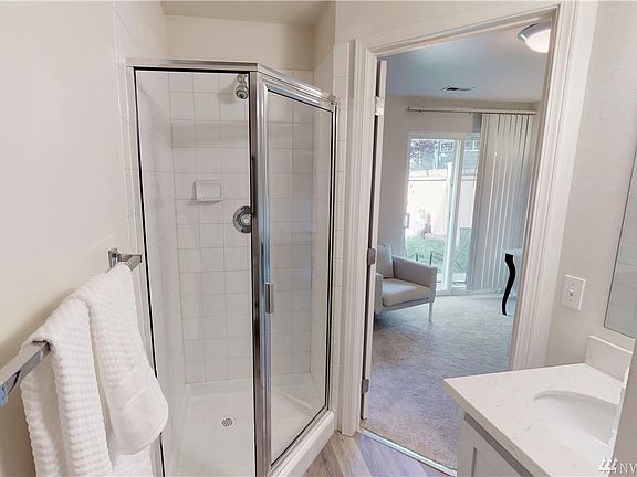 Updated lower level bathroom with new flooring, quartz counters, and an undermount sink