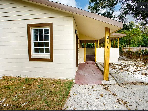 Single-family home with a spacious front yard, mature trees, and a quiet residential setting.