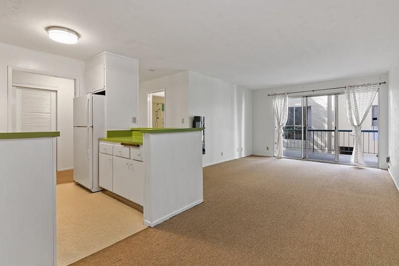 3/4 view of kitchen and living room