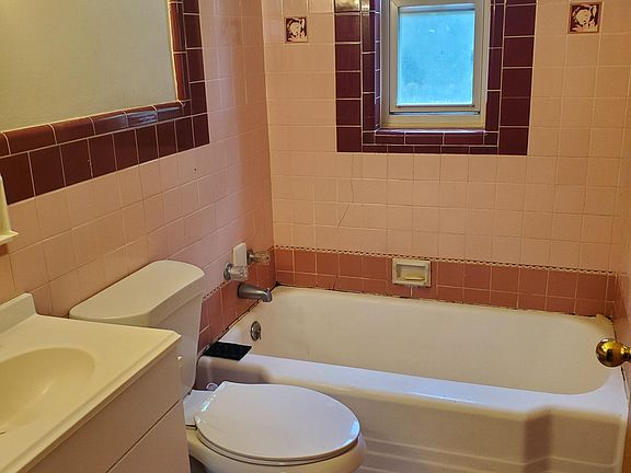 Bathroom with original tile. Tub with shower!
