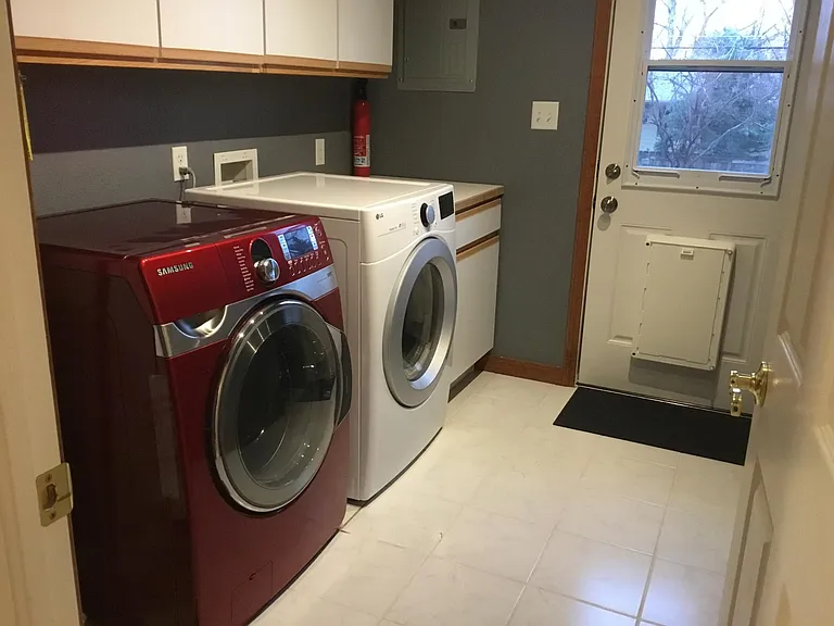 separate laundry room with newer washer and dryer