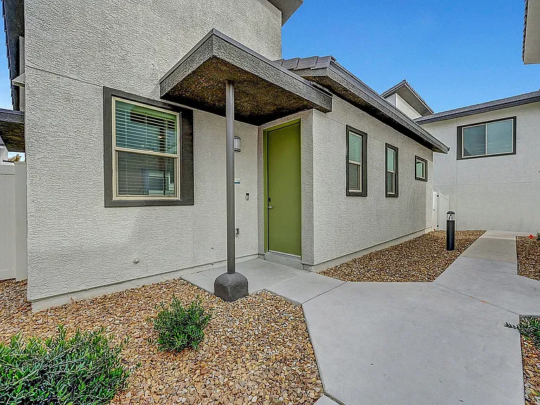 Stylish entryway featuring sleek design and elegant landscaping.