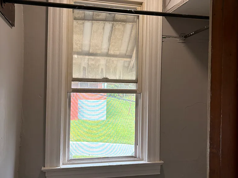 Small closet/room with hanging bar