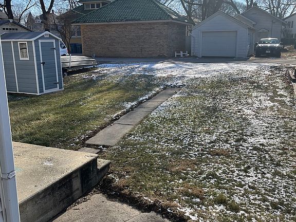 Backyard with strange shed and off alley parking.