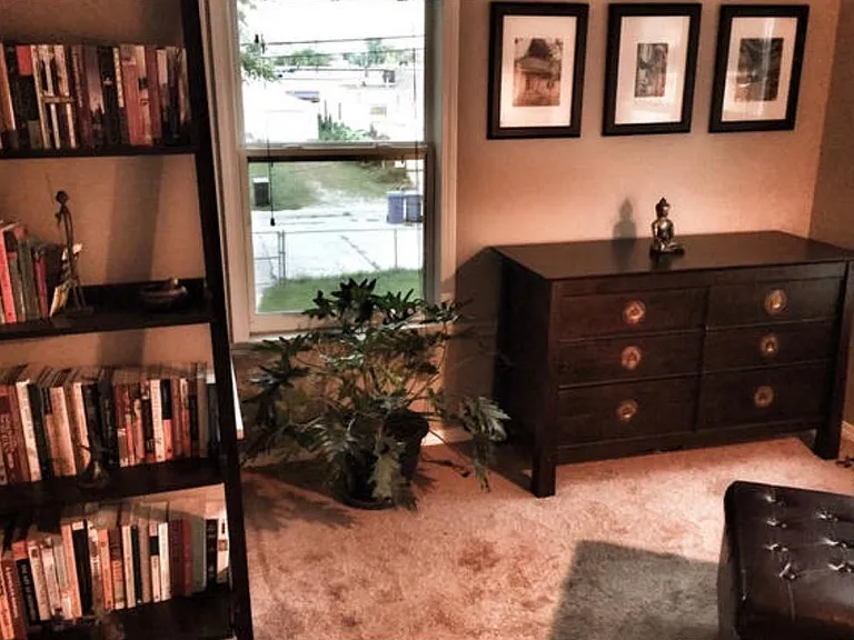 Spacious sunroom for reading or meditation space.