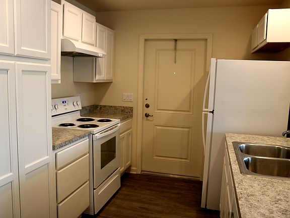 The open kitchen comes with a stove, refrigerator and dishwasher.