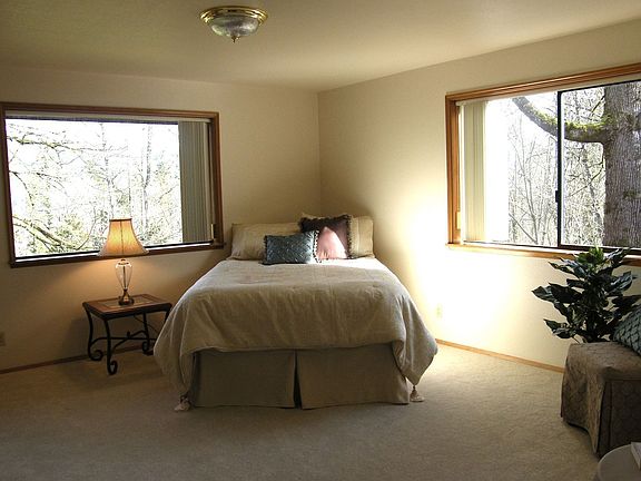 Master bedroom with sunny space including reading or sitting area