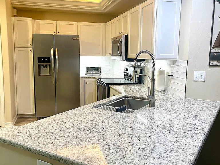 remodeled island height granite counter with extended overhand for pub chairs (furnished)