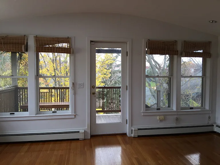 Living room overlooking balcony which overlooks Hoyt park.