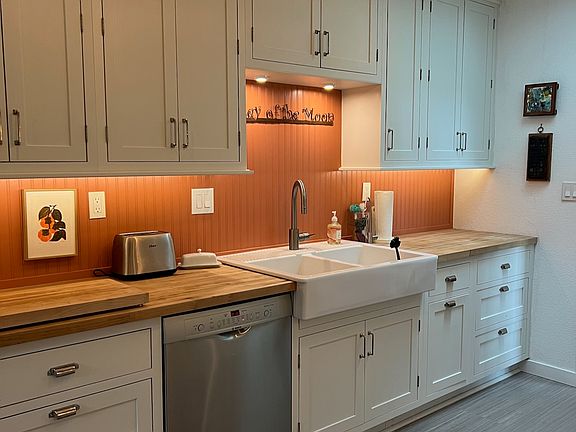 Eat-in kitchen with classic farm sink.