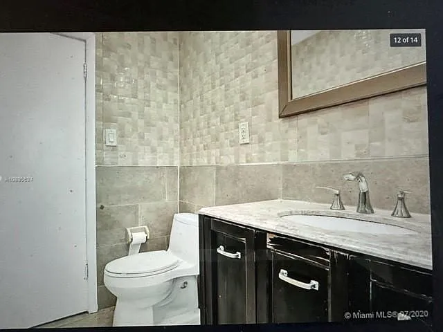 absolutely beautiful designer bath with floor to ceiling tiles and split level